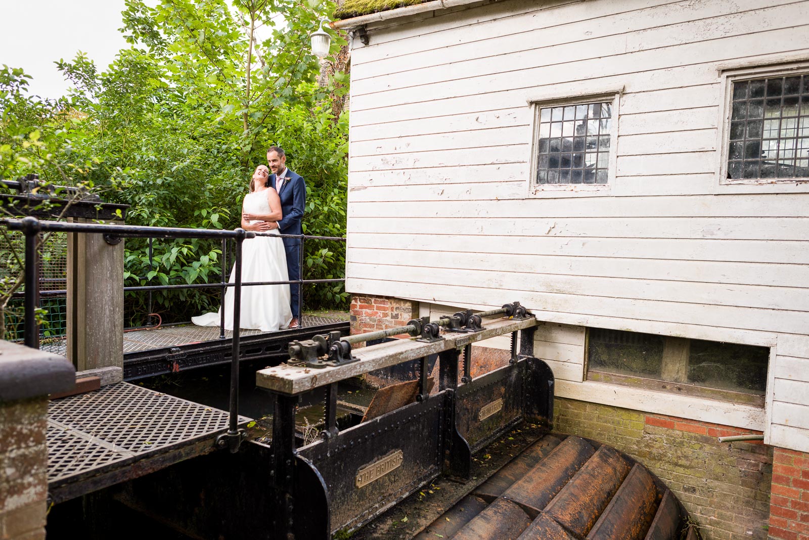 Donna and Andy photographed next to a water wheel in Halsham after their wedding.