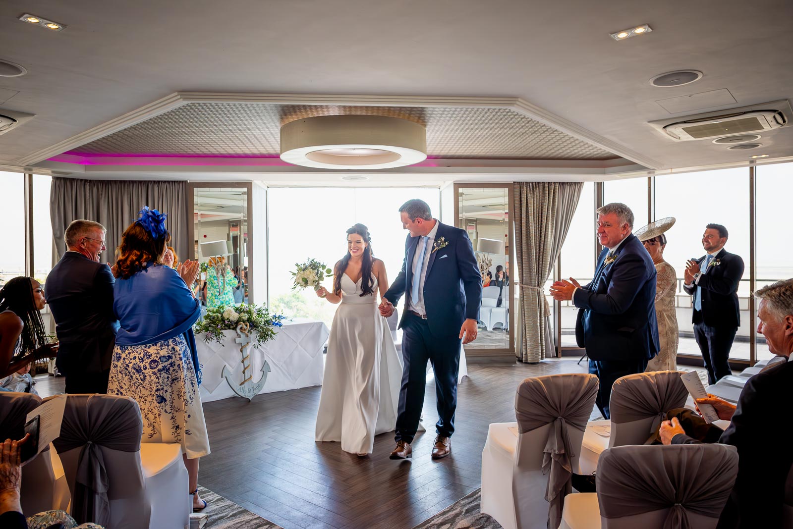 Ally and Jane are applauded by their wedding guests at Grand Hotel, Eastbourne. 