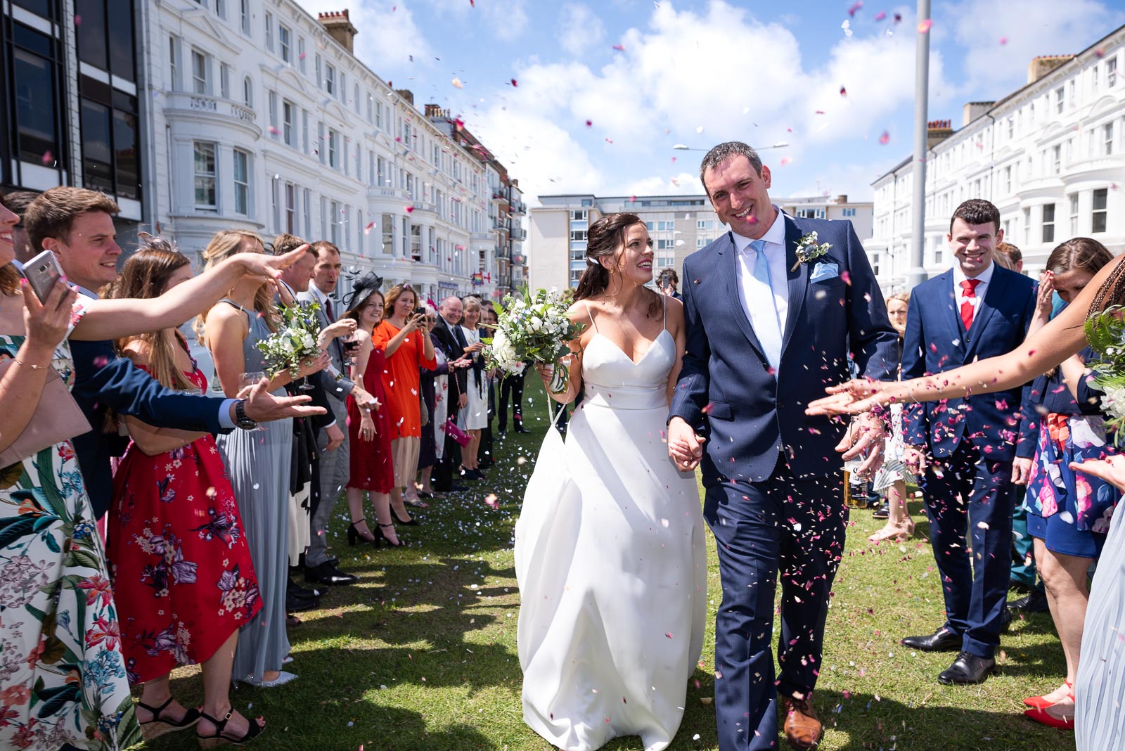 Ally and Jane are showered by confetti thrown by their Wedding Guest's at Jevington Gardens outside Grand Hotel, Eastbourne. 