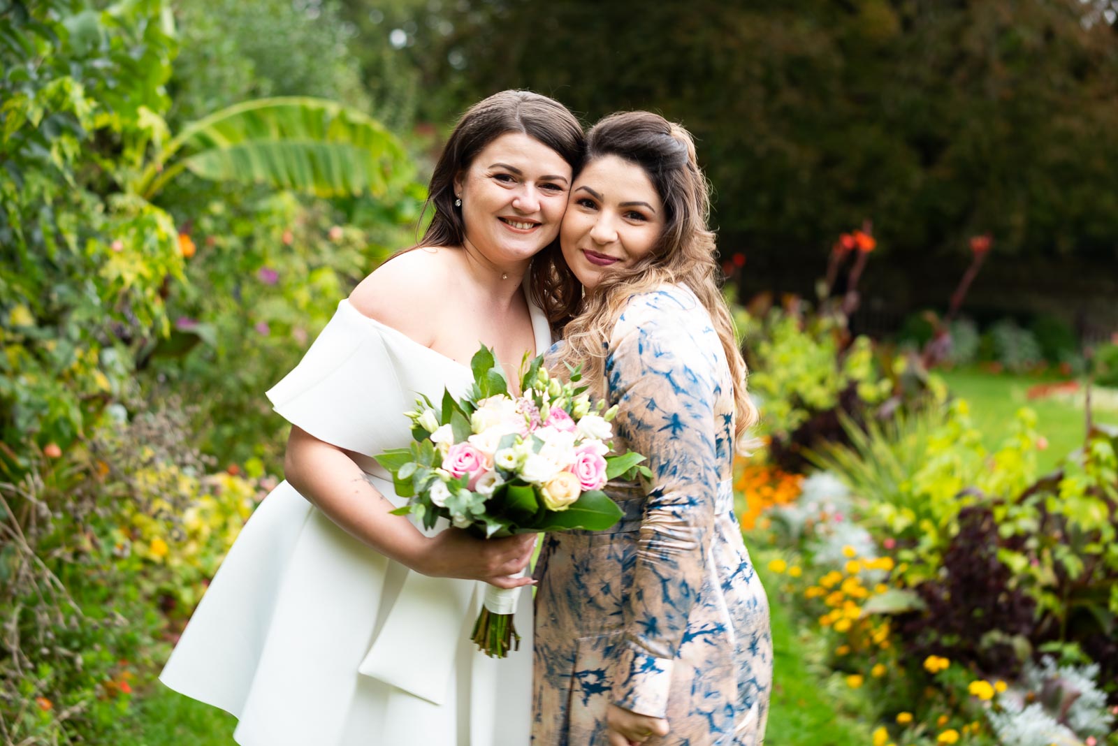 Maria poses with her maid of honour in Southover Grange, Lewes after her wedding to Robert.
