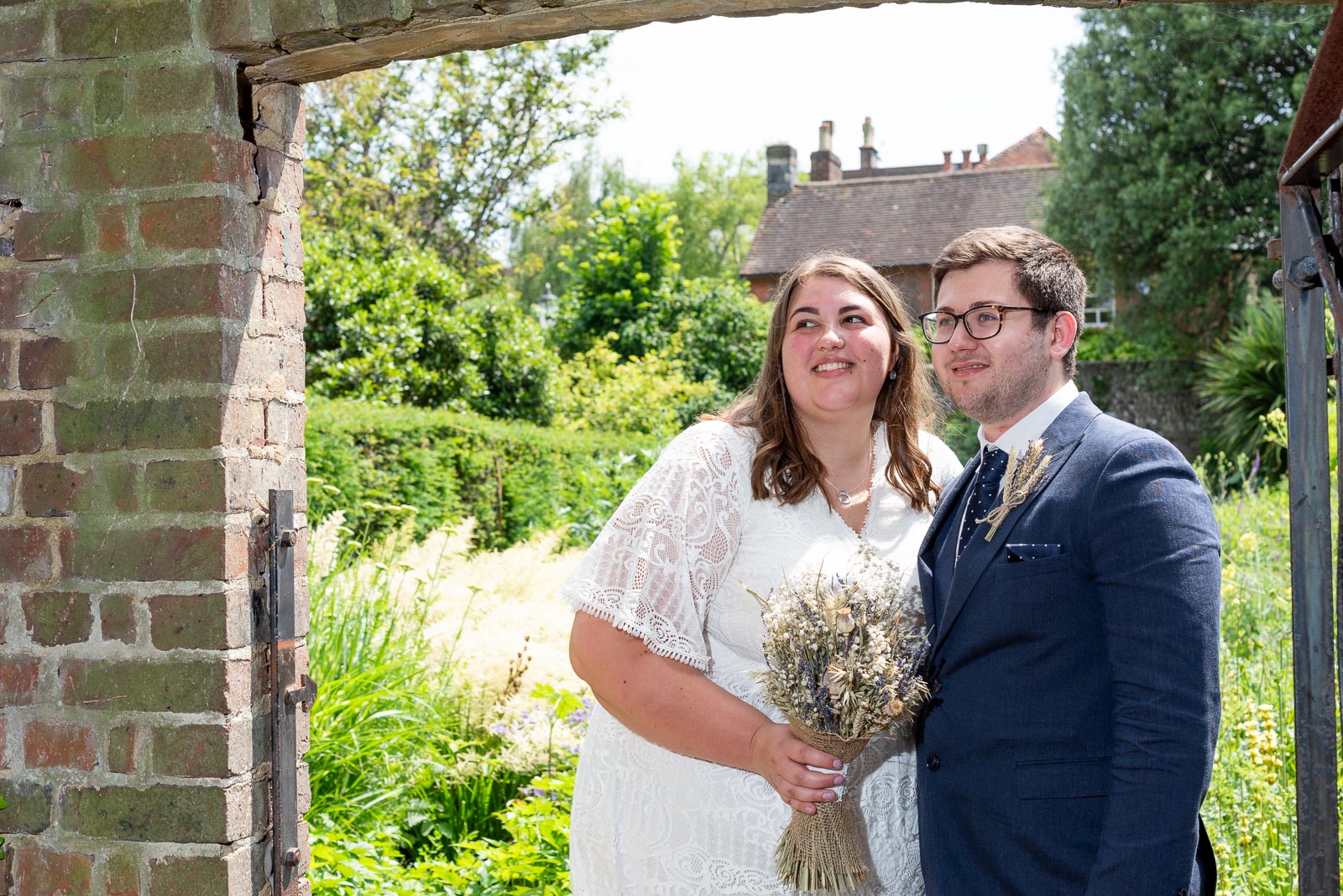 Sophie and Nathan pose in one of the arched at Southover Grange after their wedding in Lewes Register Office.