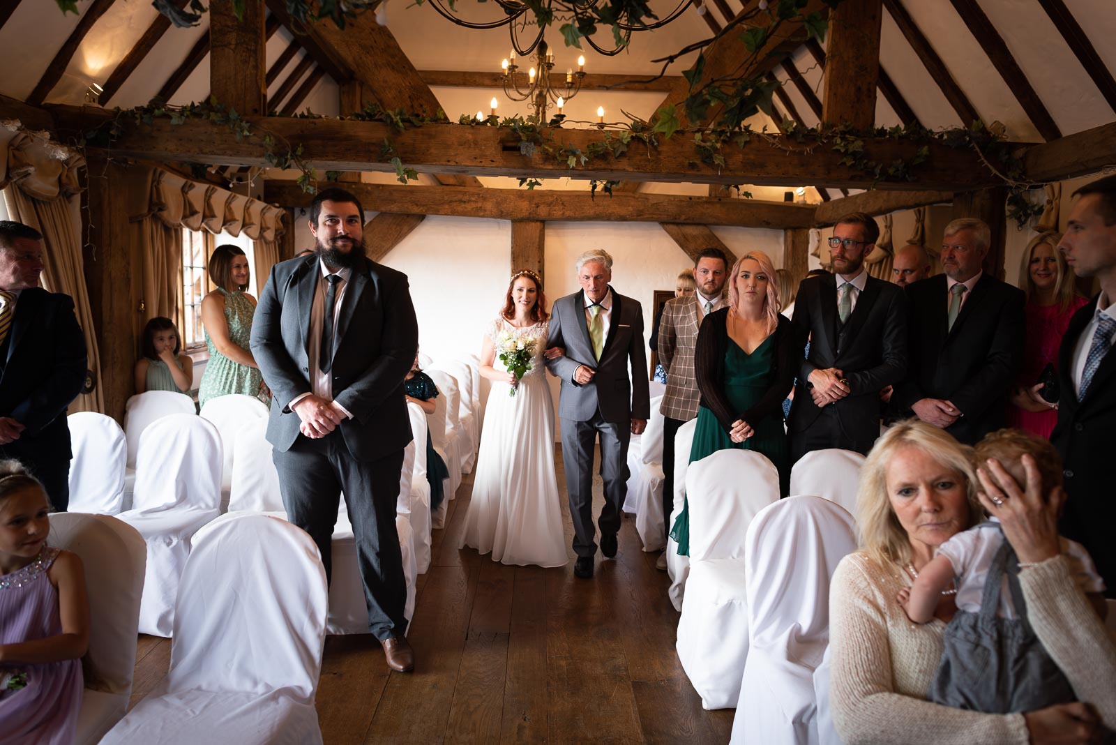 Adrienn walks down the aisle linking arms with her dad at Milwards Farm Estate near Lewes before getting married to Lee. 