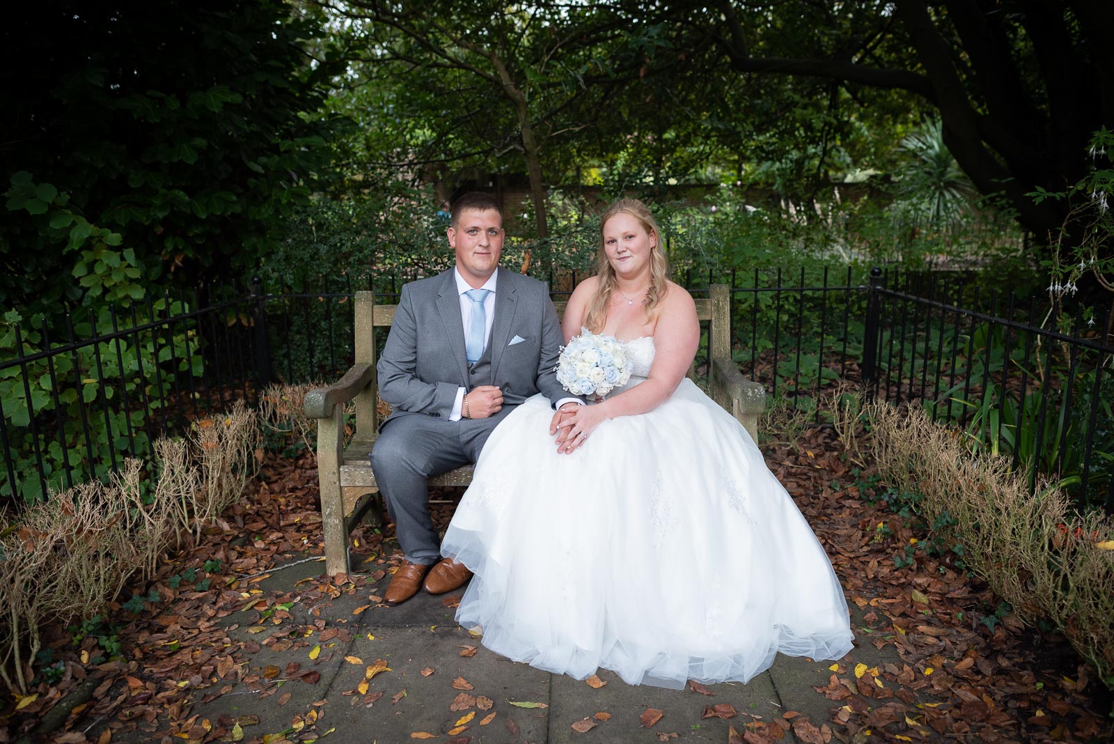 Eliana and Jacob enjoy a moment on a bench in Southover Grange after their wedding at Lewes Register Office.