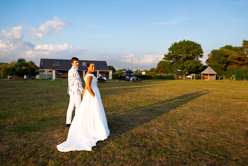 Ed and Olivia in low sunshine at Beechwood Hall after their wedding.