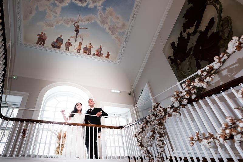 Natalie and Dean at the top of the stairs in Pelham House Hotel after their wedding.