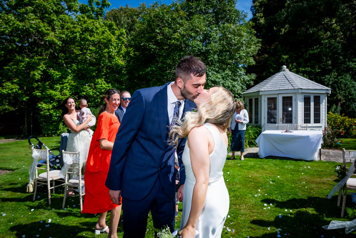 Jess and Fred kiss in the Gardens of Horsted Place Hotel after their wedding.