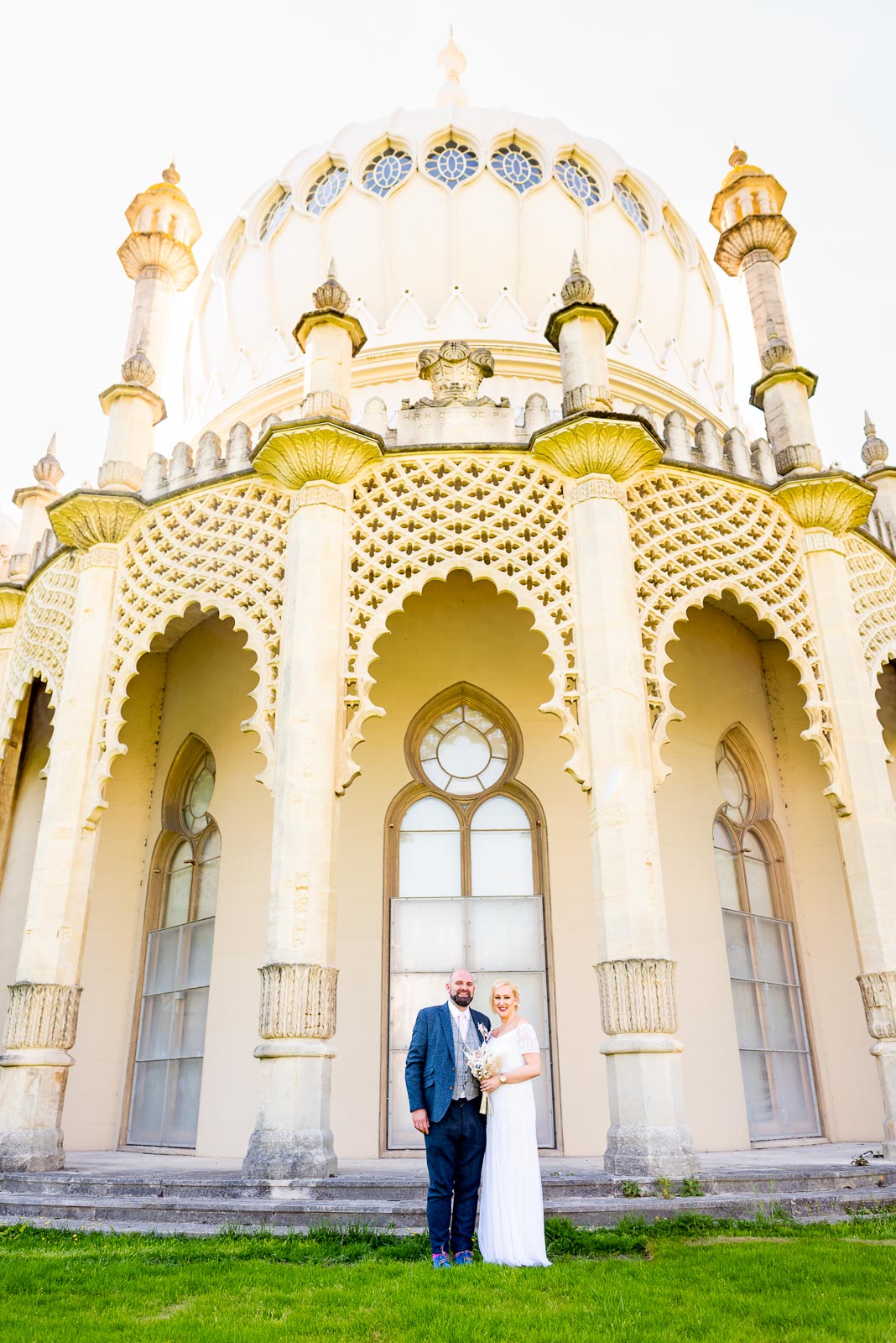 Georgina and Andy smile outside Brighton Royal Pavilion after their Wedding.