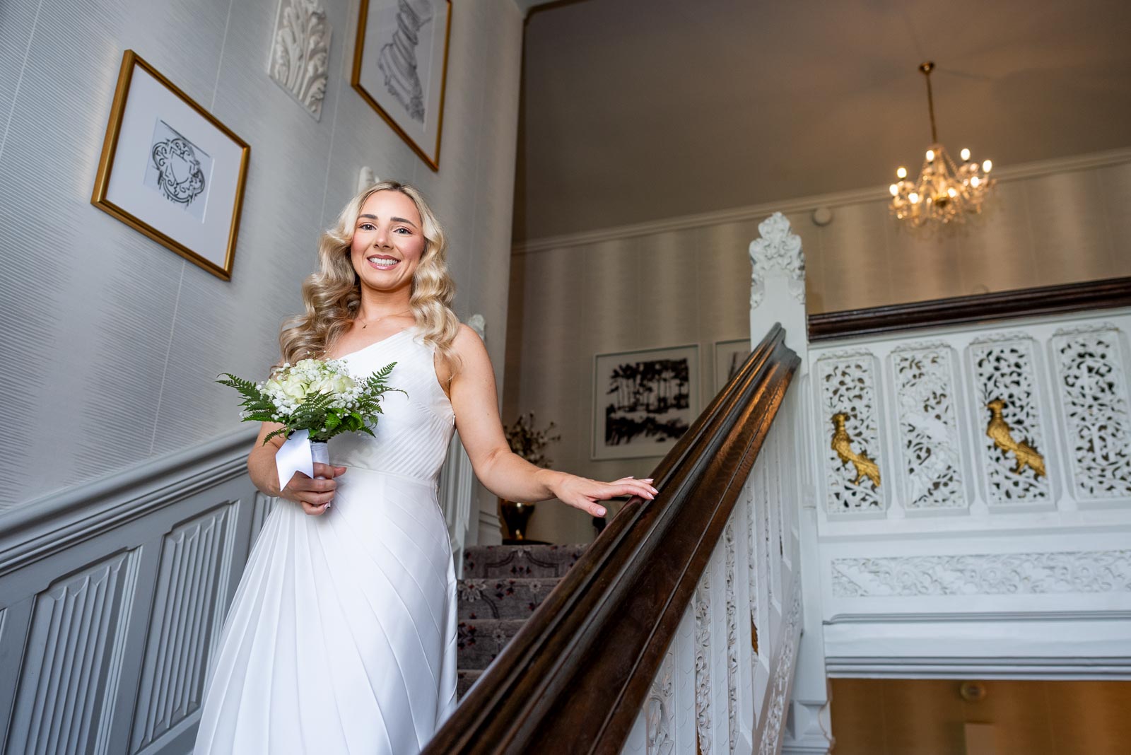 Jess descends the stairway at Horsted Place Hotel before her wedding to Fred.