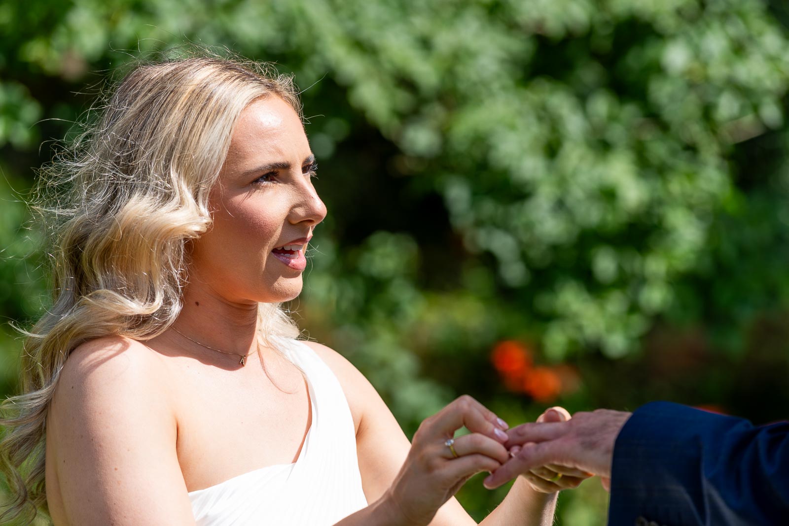 Jess places a wedding ring on Fred's finger during the ceremony in Horsted Place Hotel.