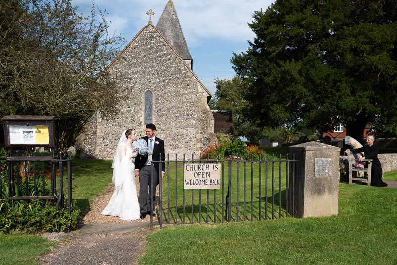 Lily and Callum outside St. Nicholas Church in Iford after their wedding.